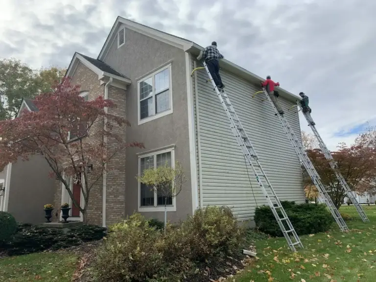 installing rain gutters on a house